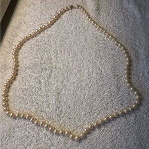 Marvella vintage champagnecolor faux pearls hand knotted strand 28” length.